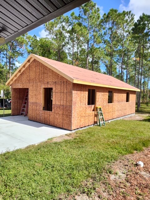 Framed and sheathed garage structure